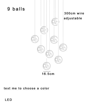 Modern colorful decorbites glass ball pendant light featuring nine clear glass globes with internal rings for dining room decor