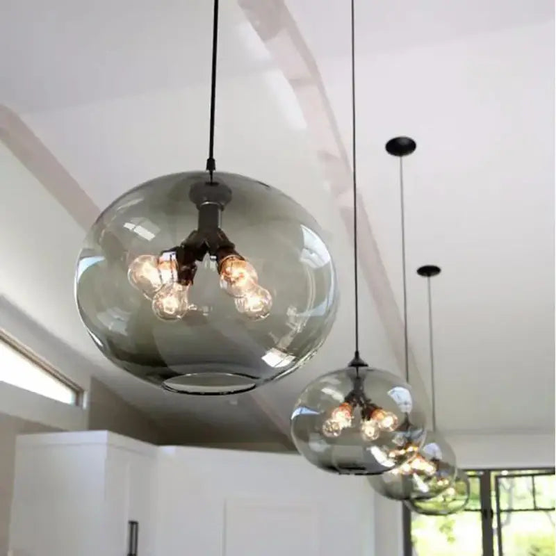 Sleek modern colorful decorbites glass bowl pendant lights with smoked glass and exposed filament bulbs for kitchen decor