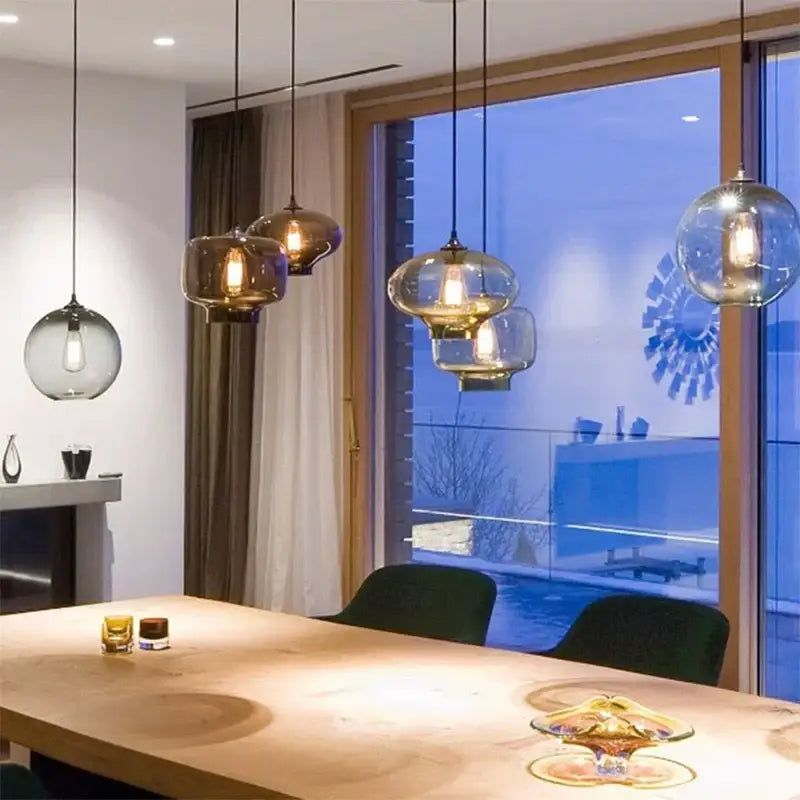 Modern colorful glass bowl pendant lights feature warm amber-toned bulbs and sleek black cords for kitchen dining decorbites glass bowl pendant