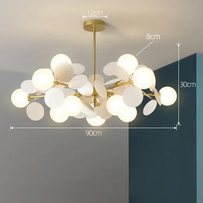 Gold-toned decorbites branch chandelier with frosted glass globe shades in a modern branching design for living room