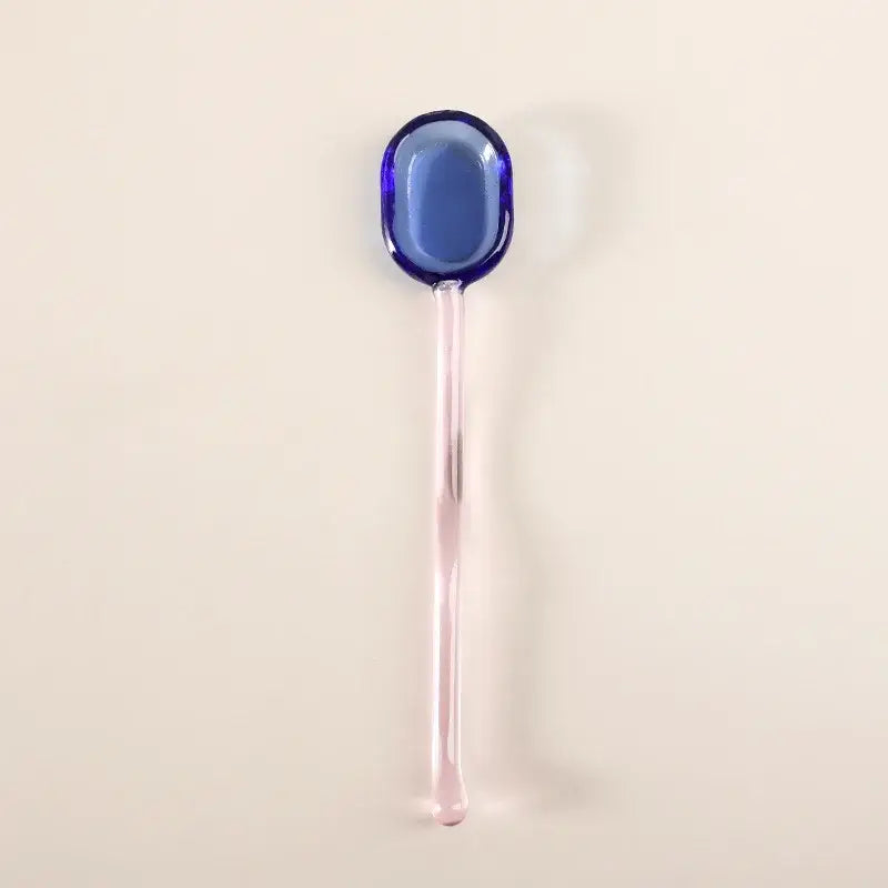 A translucent blue glass dessert spoon with a slender pink handle from decorbites dessert spoon set