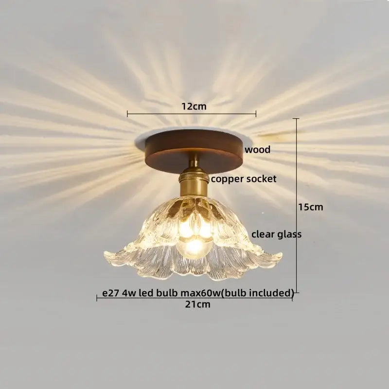 A delicate clear glass ceiling lamp with fluted petal design and brass accents for decorbites colorful glass led lighting