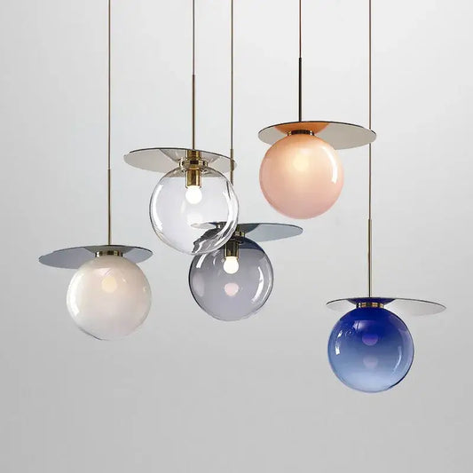 Modern colorful glass metal pendant lamp with spherical shades in clear, blush pink, frosted white, and gradient blue by decorbites
