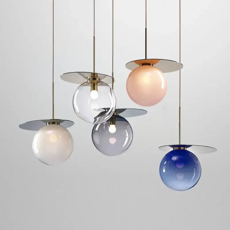 Modern colorful glass metal pendant lamp with spherical shades in clear, blush pink, frosted white, and gradient blue by decorbites