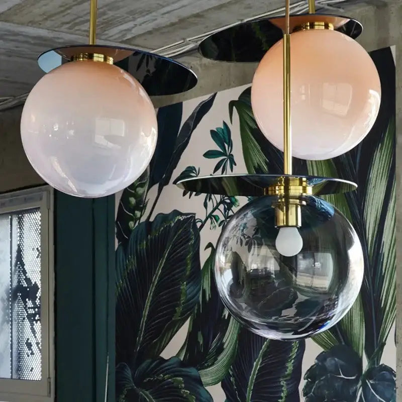 Three spherical pendant lights with brass fixtures and frosted pink and clear glass globes decorbites colorful glass metal lamp