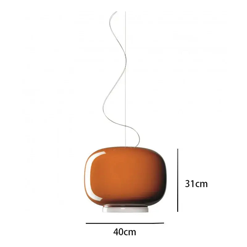 A sleek amber-colored glass pendant light with a smooth rounded body and metallic suspension cord for decorbites colorful glass