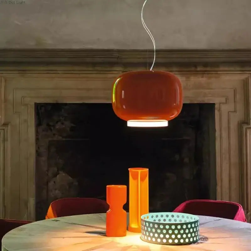 A sleek rounded orange pendant light with a glossy finish from decorbites colorful glass pendant lights collection