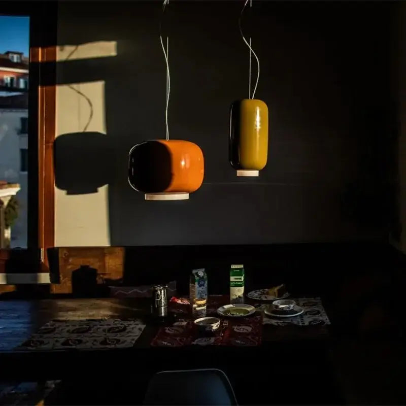 Two modern pendant lights in orange and mustard yellow glossy ceramic finish for dining room decorbites colorful glass pendant