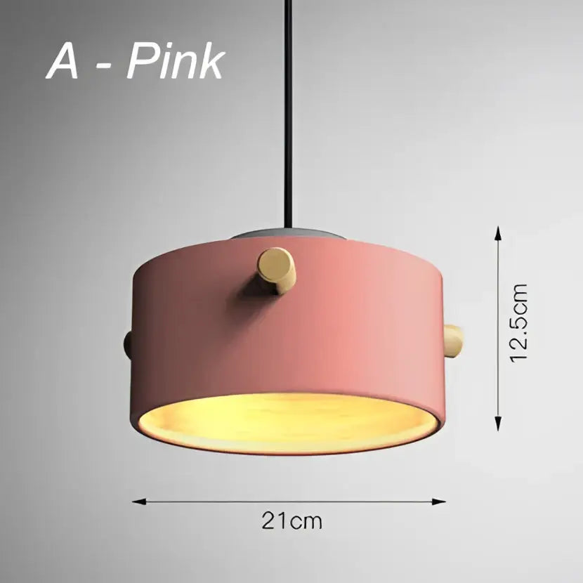 Pink cylindrical pendant lights with gold-toned hardware and warm yellow interior glow for decorbites colorful led dining room decor