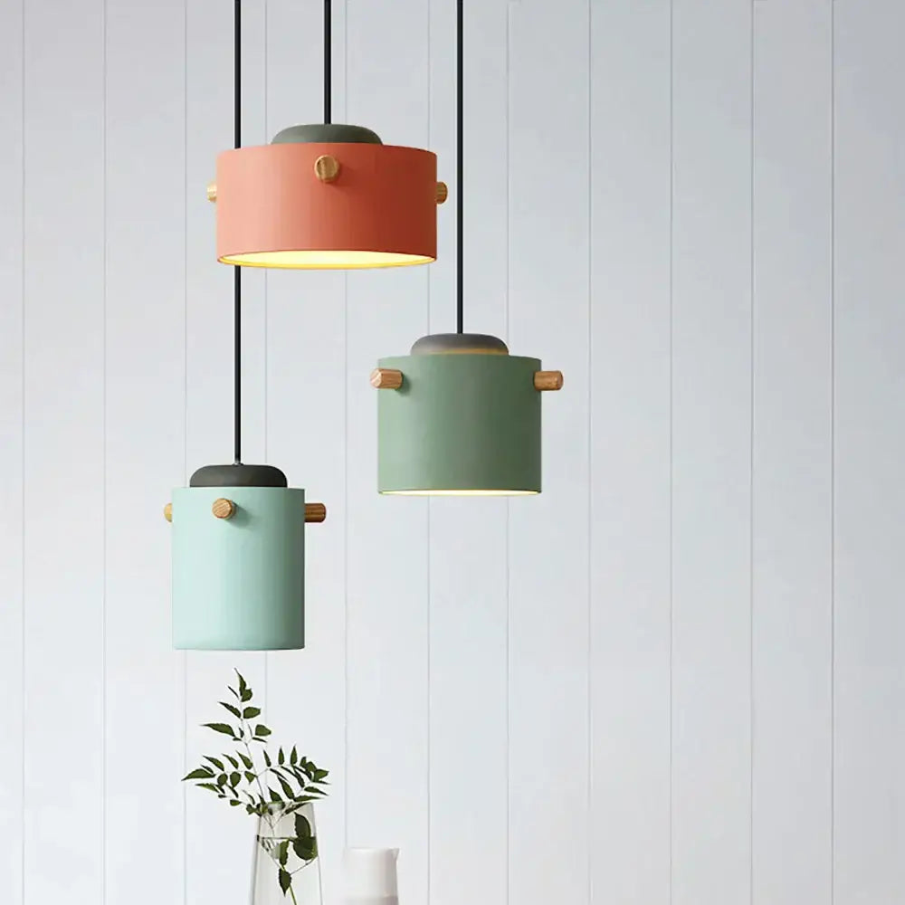 Three modern cylindrical decorbites colorful led pendant lights in pastel peach mint and sage green for dining room decor