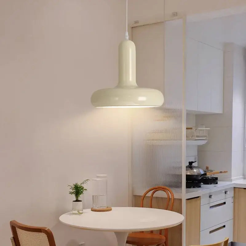 Cream-colored modern pendant light with painted aluminum finish and glossy surface for kitchen and dining room use