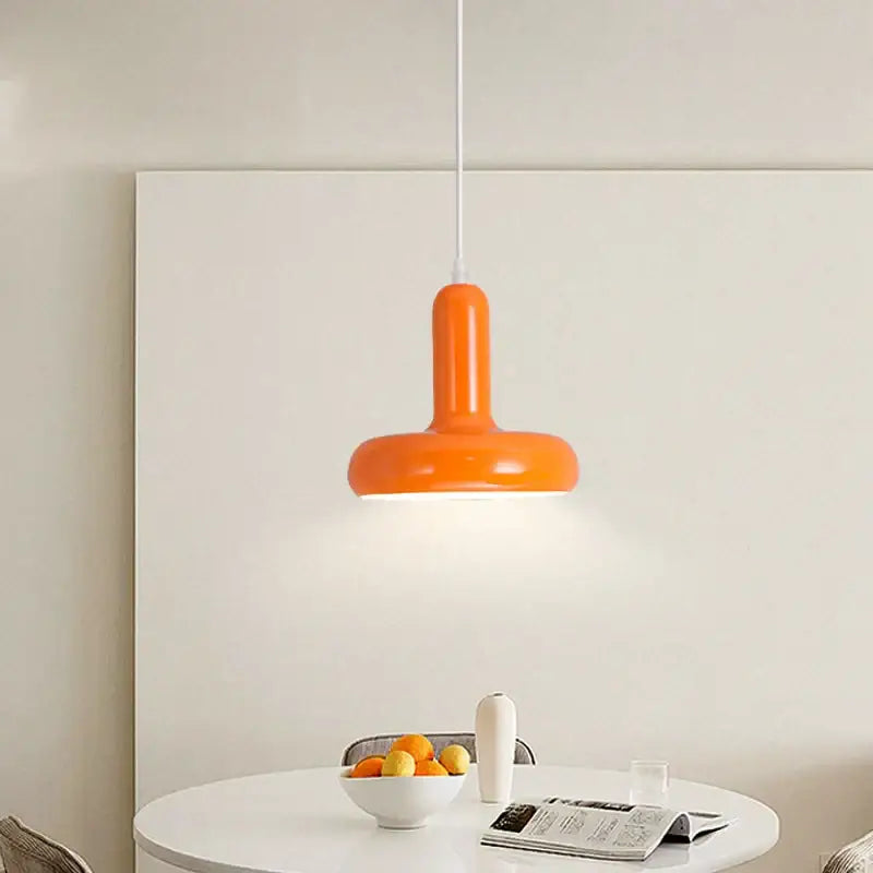 Vibrant orange painted aluminum pendant light with sleek modern design and glossy aluminum finish for kitchen or dining room