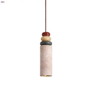 Modern pendant light with a beige concrete cylinder topped by colorful stone led in red yellowish beige and dark gray for dining room decorbites colorful stone