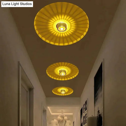 Three golden sunburst decorbites™ recessed ceiling lights with metallic fixtures for indoor gallery and corridor use