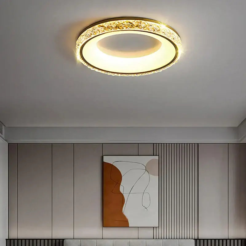 Gold-toned concave round decorbites ceiling light with crystal-encrusted outer ring and warm white illumination for living room