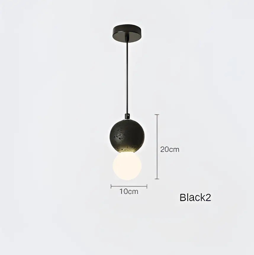 Modern black glass pendant light with perforated iron finish upper half and smooth lower globe for dining room