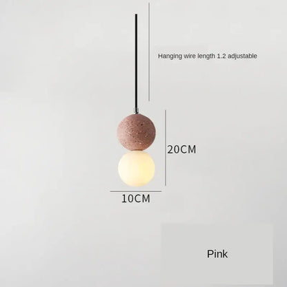 Modern concrete and glass pendant light with pink spherical iron finish featuring textured upper and smooth illuminated globe