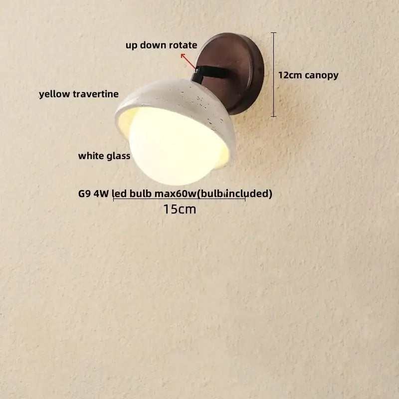 Modern concrete and wood led wall sconce with white speckled glass globe mounted on dark brown yellow travertine fixture