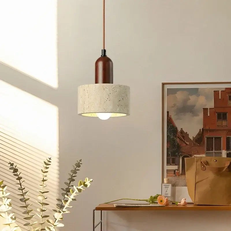 A modern pendant light with a textured concrete shade and dark wood neck in led yellow travertine decorbites led yellow