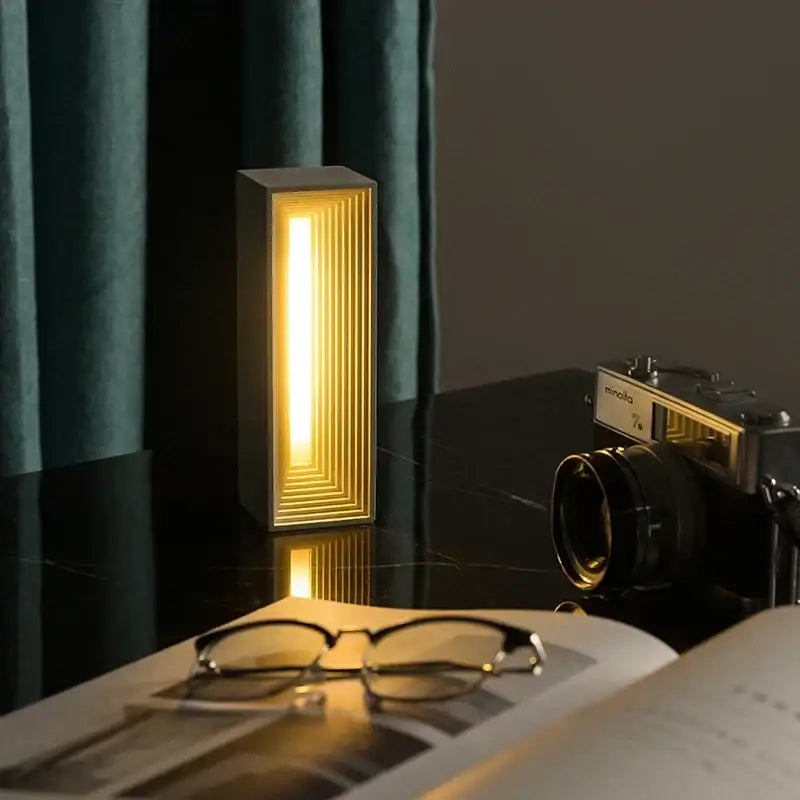 Modern concrete stone table lamp with golden ridges emitting warm light perfect as a bedroom stone table lamp decorbites concrete stone