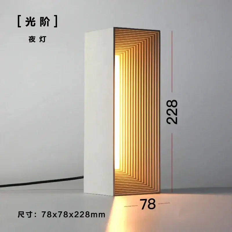 Modern concrete stone table lamp with white rectangular body and warm golden wood slat interior for bedroom decorbites concrete stone