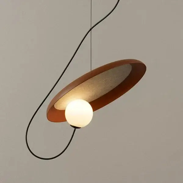 Modern copper and black grid led pendant light with warm matte circular shade and glowing bulb for dining room decorbites grid led