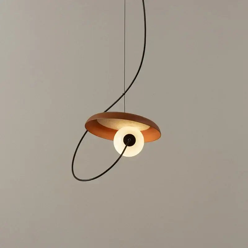 Modern copper and black grid led pendant light with warm circular shade and black curved cable for dining room decorbites grid led