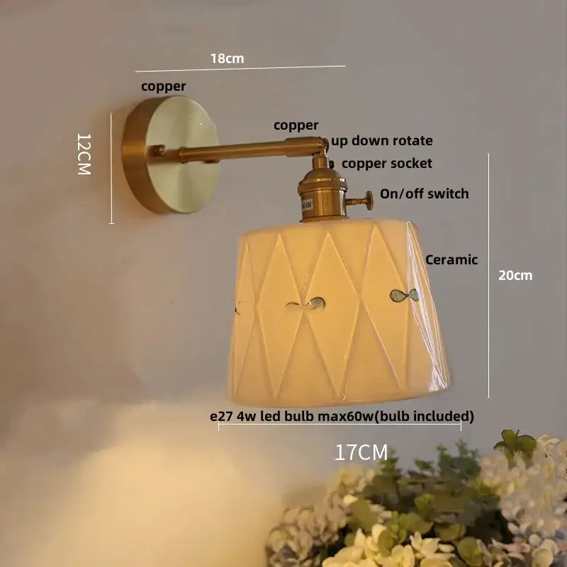 Modern copper and off-white ribbed wall light fixture with geometric ceramic shade featuring subtle fish motifs
