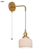Modern copper wall light fixture with off-white ribbed glass shade and twisted cord for bedroom sconce lighting