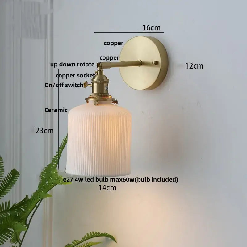 Modern copper and off-white ribbed wall light fixture with brass-finished copper arm and circular backplate for bedroom use