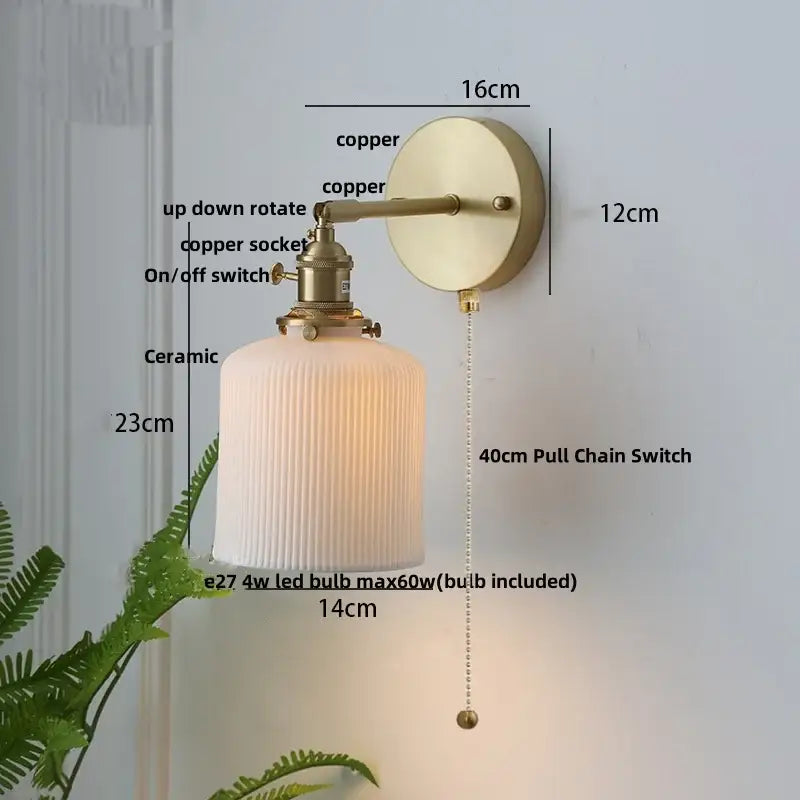 Vintage-style wall light fixture with brass-finished copper arm and off-white ribbed ceramic shade for bedroom use