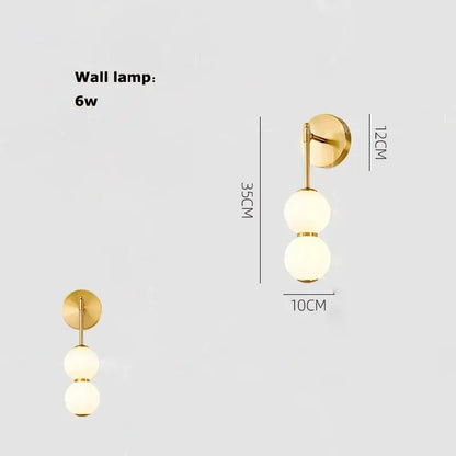Gold-finished pendant light with two frosted glass spheres for decorbites burly wood walnut living room decor