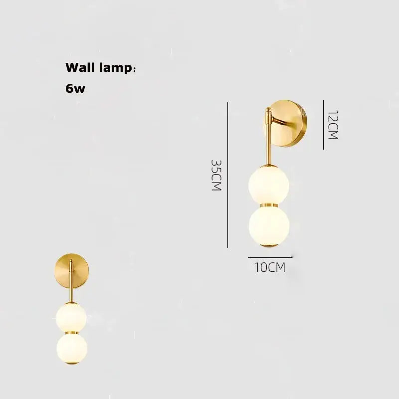 Gold-finished pendant light with two frosted glass spheres for decorbites burly wood walnut living room decor