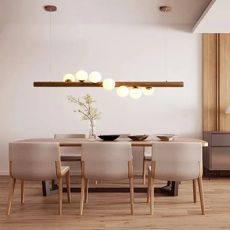 Modern copper and white glass pendant light with spherical frosted bulbs on decorbites burly wood walnut fixture