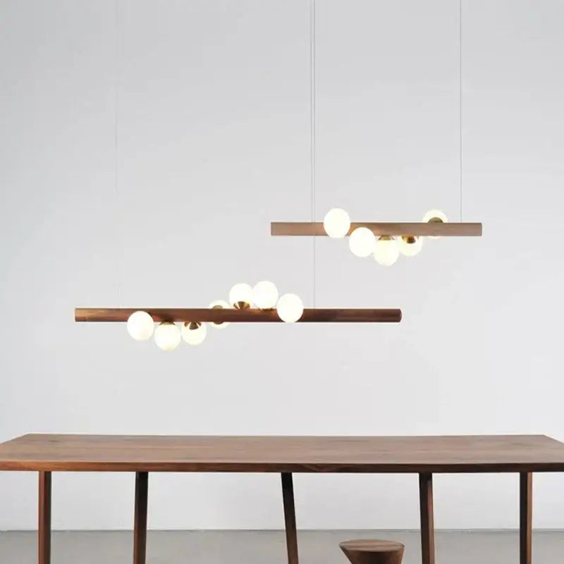 Modern wooden pendant light with spherical glass bulbs and brass accents for decorbites burly wood walnut decor