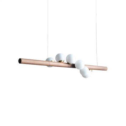 A modern pendant light with a copper tube and five matte white glass bulbs for decorbites burly wood decor