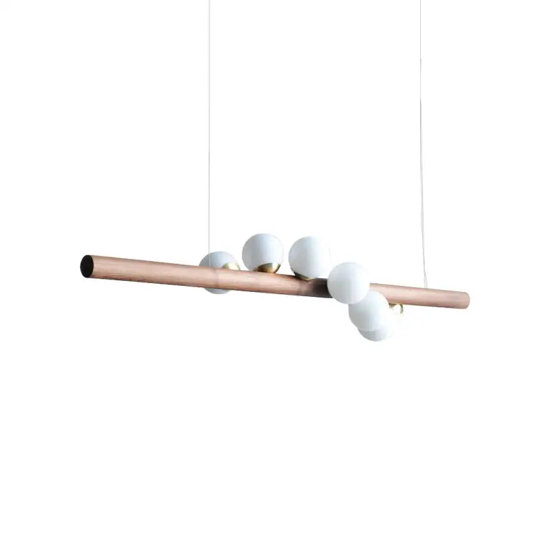 A modern pendant light with a copper tube and five matte white glass bulbs for decorbites burly wood decor