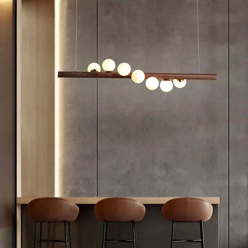 Modern copper and white glass pendant light with burly wood walnut bar and six frosted globe bulbs for living room decorbites