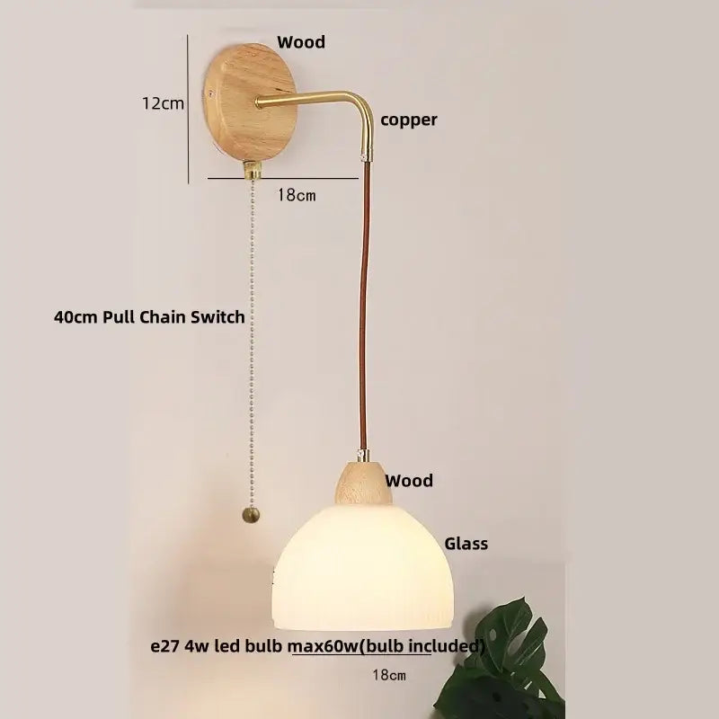 Modern copper and wood wall sconce with natural wood base, clear glass dome, and pull chain switch for easy use