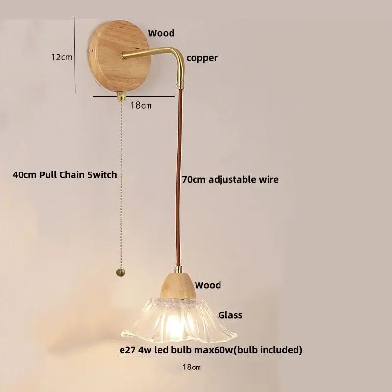 Modern copper and wood wall sconce with clear glass bell shade and pull chain switch on circular wooden backplate