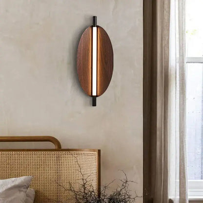 Modern brown metal leaf wall sconce with oval warm wood finish and sleek black metal decorbites brown metal accents