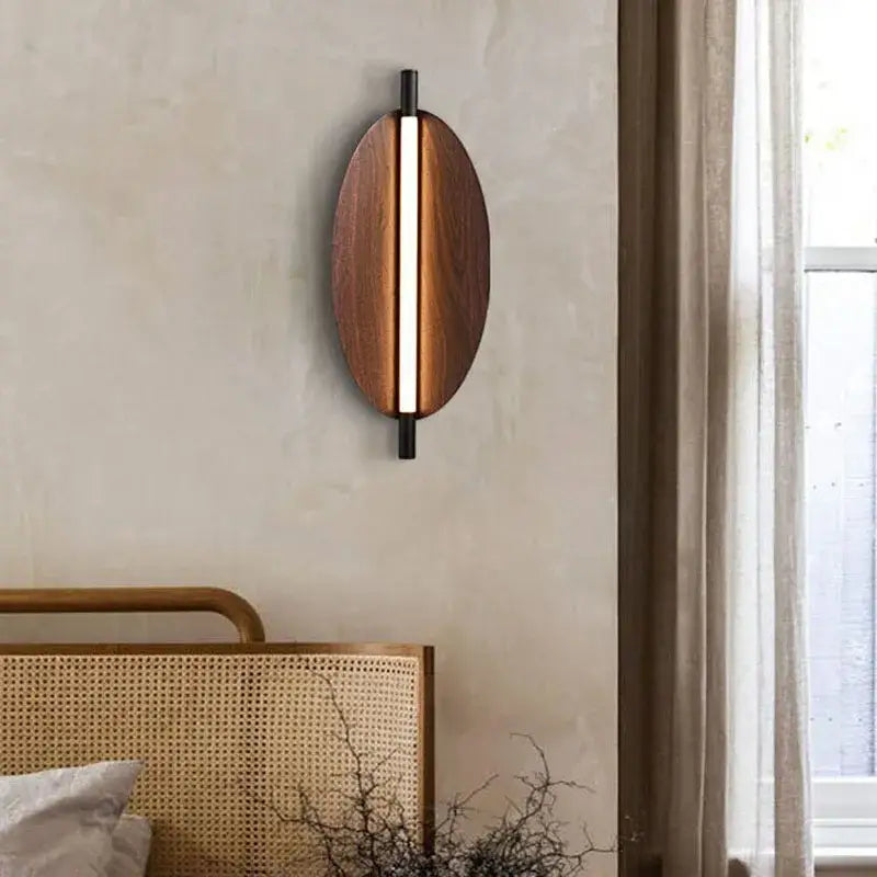 Modern brown metal leaf wall sconce with oval warm wood finish and sleek black metal decorbites brown metal accents