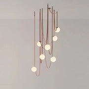 A modern copper decorbites glass ball pendant lamp with seven frosted glass bulbs for dining room lighting