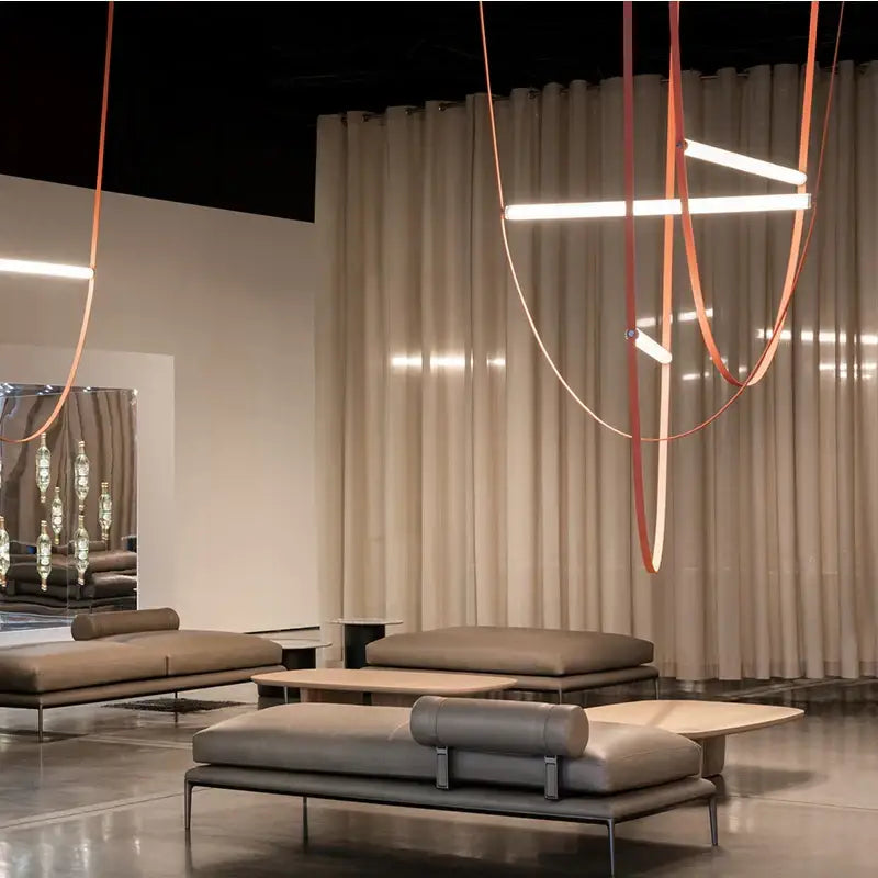 Modern minimalist lounge sofas with sleek metal frames and taupe leather upholstery complement decorbites leather belt chandelier for dining room