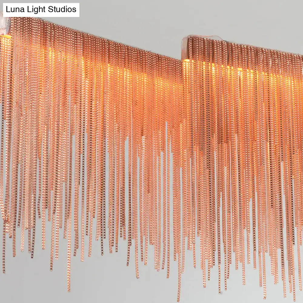A modern decorbites contemporary metal gold led linear island pendant light with cascading copper-toned metal bead chains