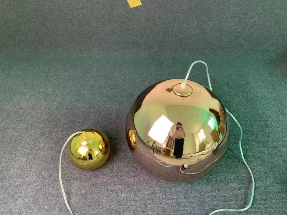Modern copper glass balls pendant light featuring shiny gold spherical decorbites glass balls with reflective surfaces and white cords