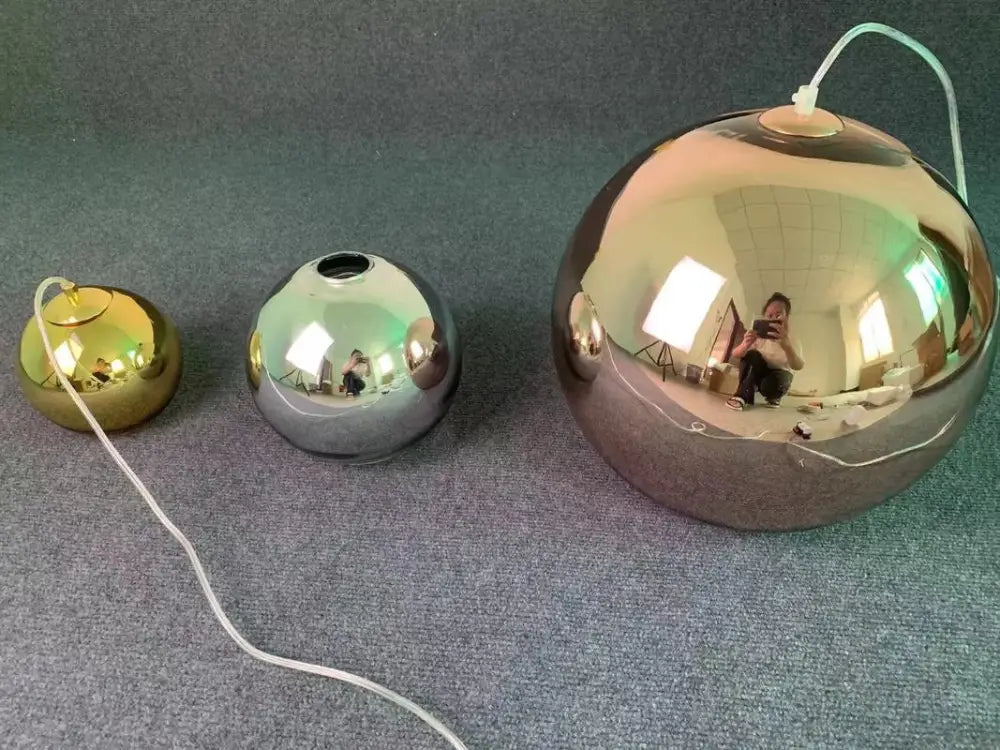 Modern copper glass balls pendant light featuring shiny metallic spherical pendant lamps in gold silver and bronze finishes