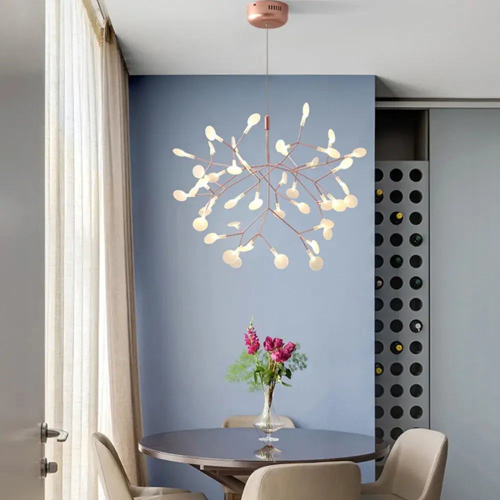 A modern copper decorbites heracleum chandelier with rose gold branching arms and frosted glass globe lights for dining room decor