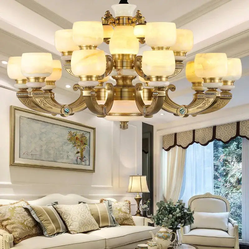 Modern copper jade chandelier with gold-toned ornate arms and frosted warm-lit glass shades for living room lighting