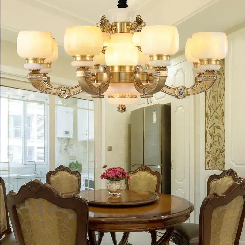 Modern copper jade chandelier with gold-toned metalwork and frosted glass shades for elegant living room lighting
